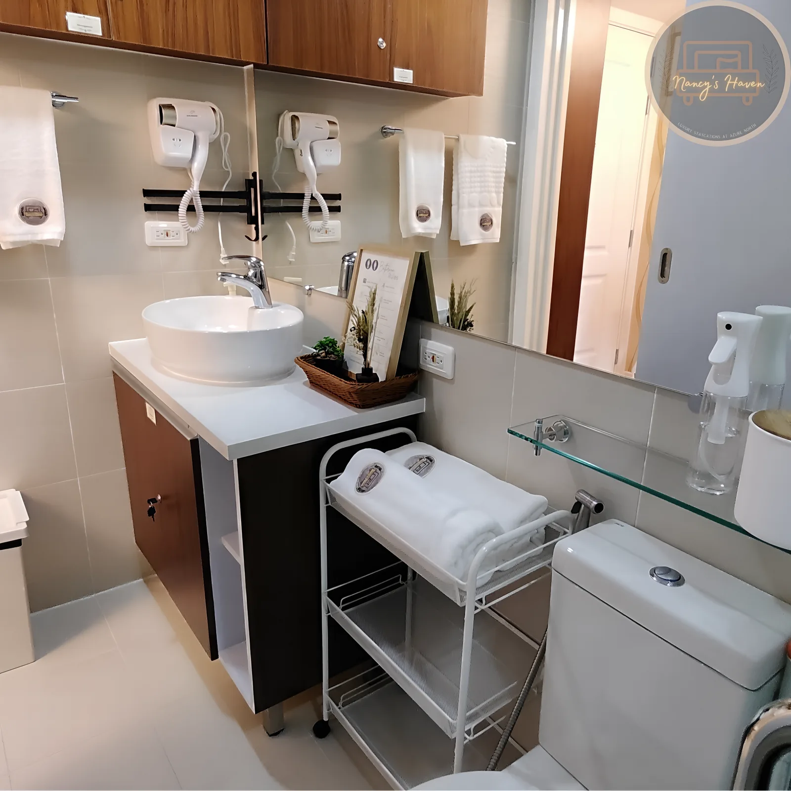 The bathroom — a clean vanity with vessel sink, mirror, and fresh towels